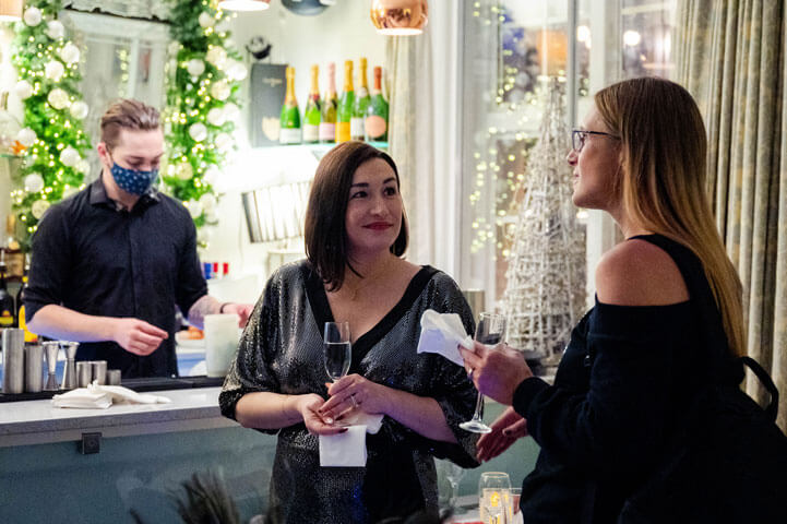 Two women chatting at Spotlight Holiday Party