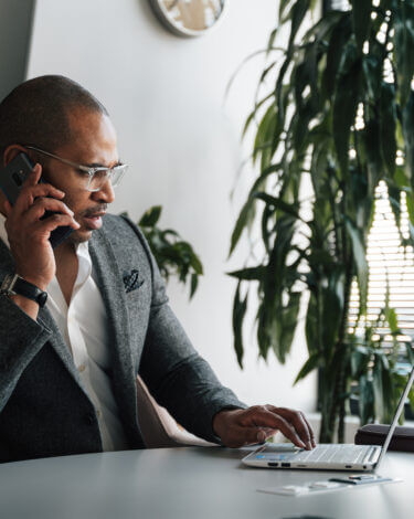 A modern business man working in and around his office space.